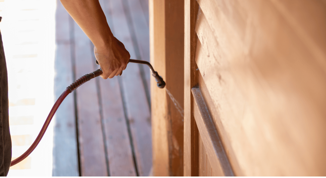 hand , probe spreading the liquid, wood deck 